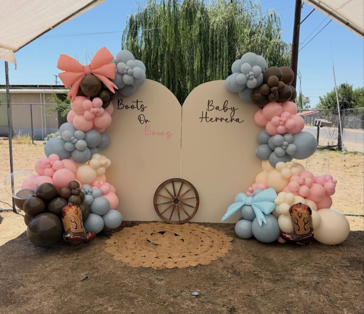 Boots or Bows western gender reveal backdrop with pink, blue and brown balloons, bows and cowboy boots